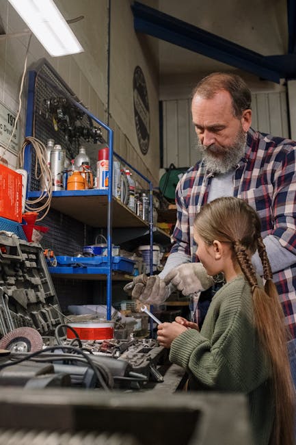Dad teaching daughter car mechanics in a garage, emphasizing family bonding and practical skills.