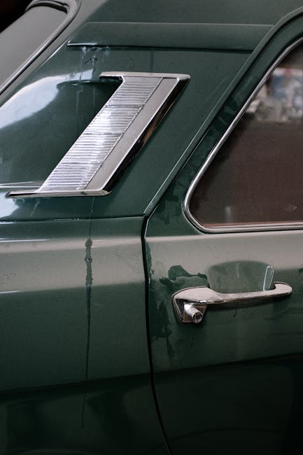 Detailed view of a vintage car door with chrome accents, showcasing retro automotive design.